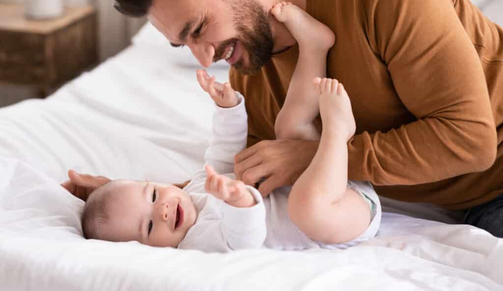 Happy Father And Little Baby Playing Together Bonding At Home